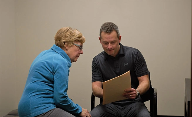 Dr. Eric Mayfield reviewing information with a patient during a session.